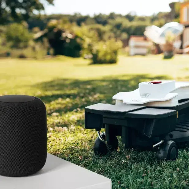 Ambrogio Lifestyle Smart product on table with robot in lawn