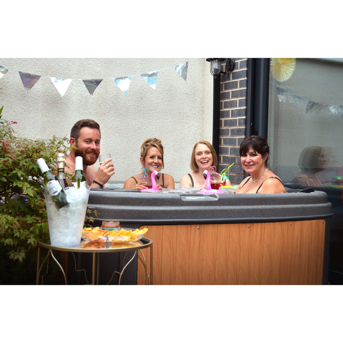 RotoSpa DuraSpa S160 Granite grey and teak lifestyle outdoor arrangement with 4 people drinking in the tub