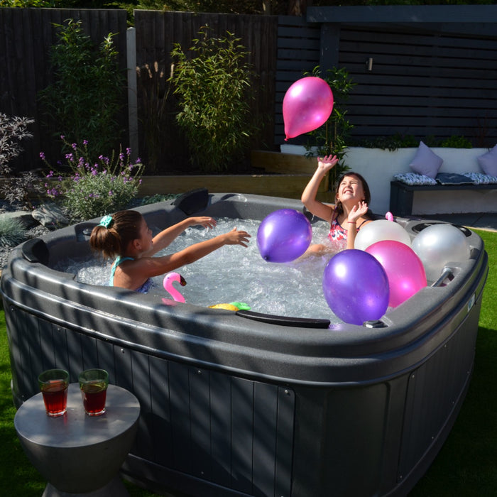 RotoSpa DuraSpa S380 Granite grey and grey lifestyle outdoor arrangement with kids and balloons