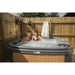 RotoSpa DuraSpa S380 Granite grey and teak lifestyle outdoor arrangement with couple in tub