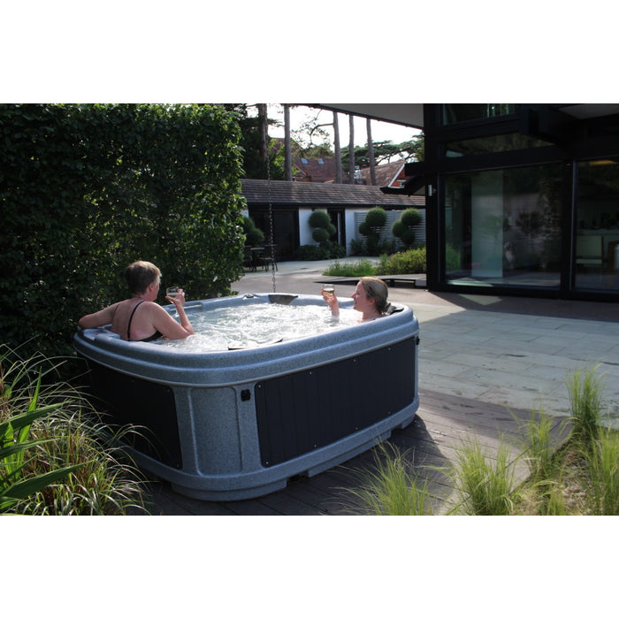 RotoSpa DuraSpa S380 Light grey and grey lifestyle outdoor arrangement with 2 people drinking in tub