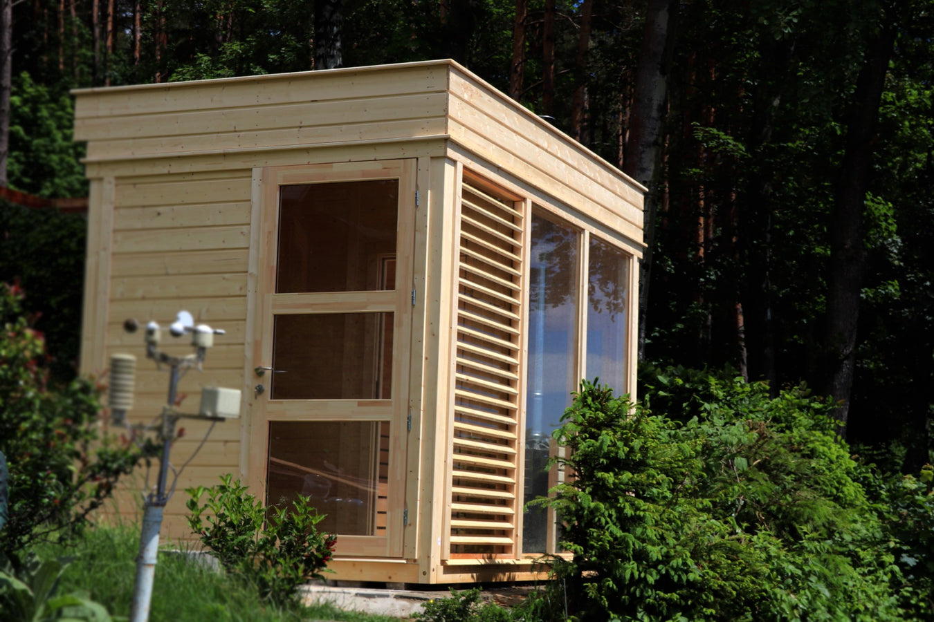 Sauna cube lifestyle outdoor arrangement on a wooden platform