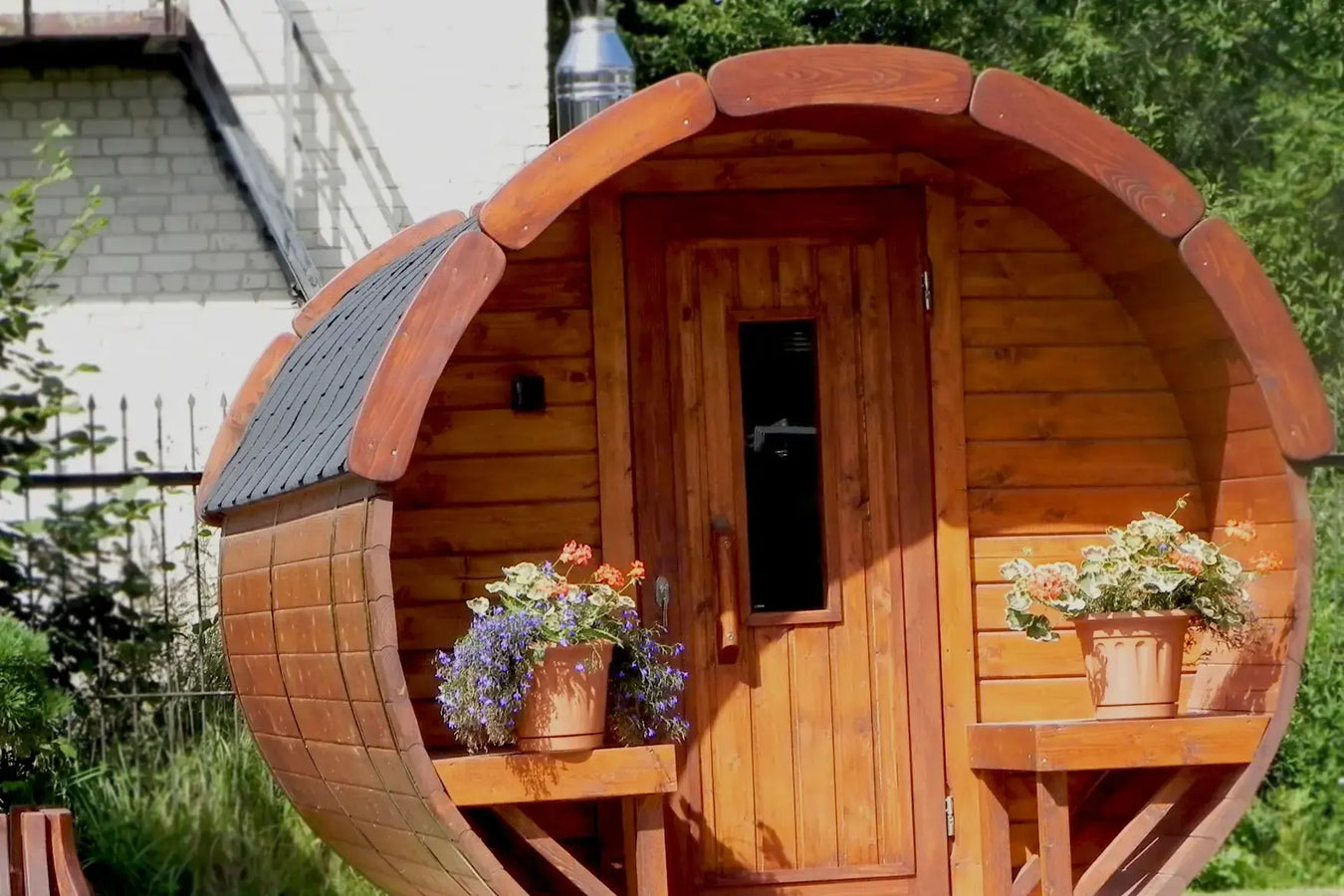 barrel sauna with flower pots on terrace