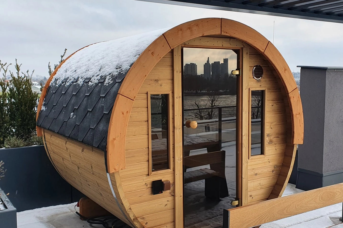 barrel sauna with snow covered roof