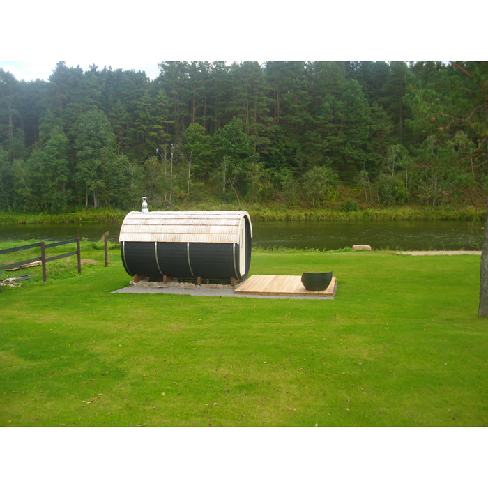 Viking Industrier Barrel Sauna 2.2 x 4m outdoor arrangement far view wooden shingles with couch on wood platform