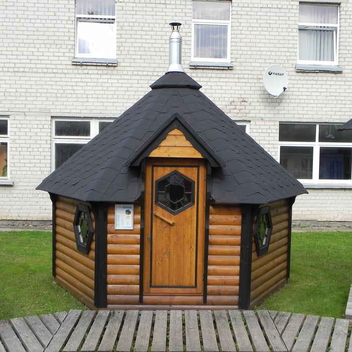 Viking Industrier Sauna Cabin 9.2m² with Changing Room beside building front lifestyle view with black roof and decorative windows